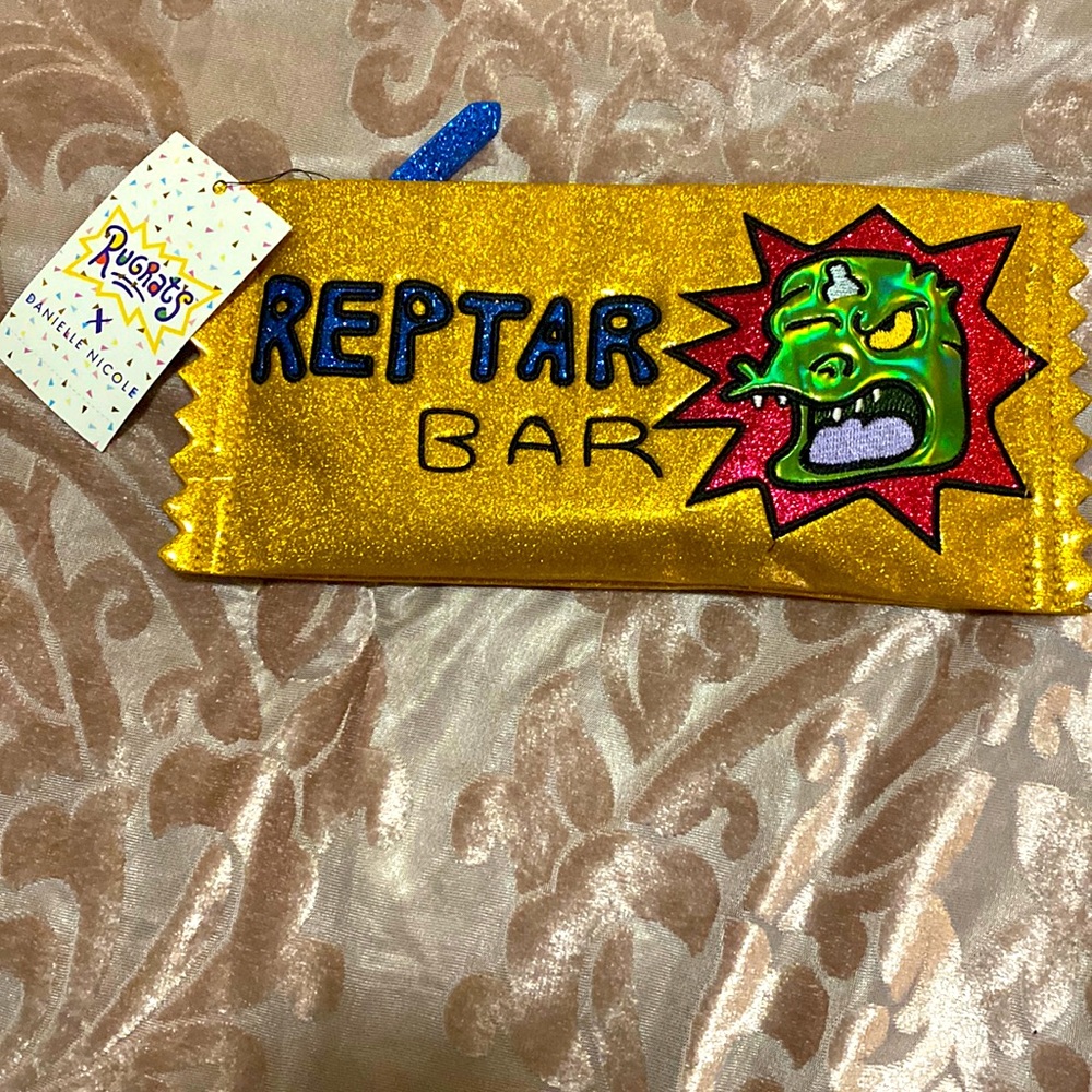- Gold multi-colored glitter Rugrats zip pouch by Danielle Nicole.
